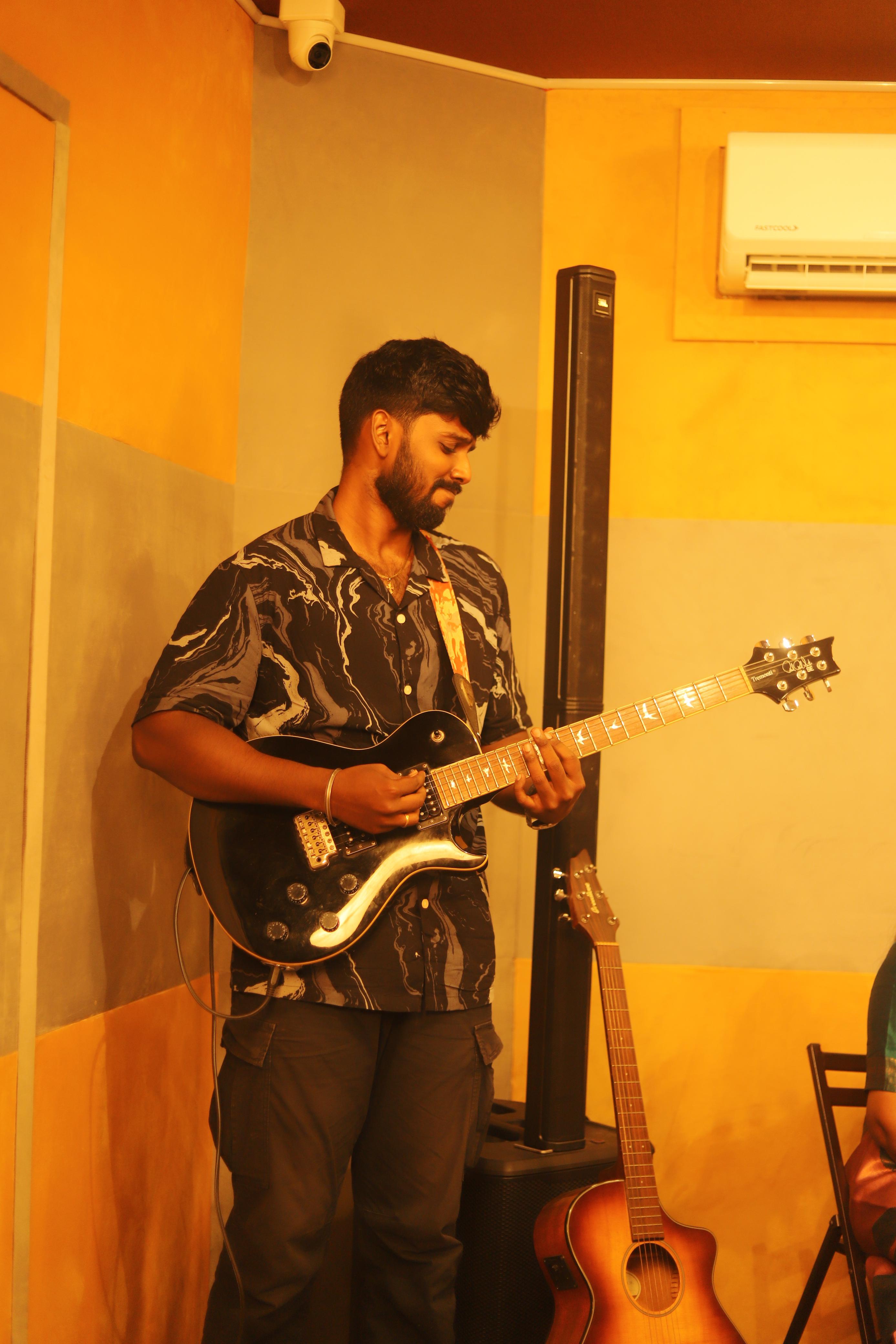 Francis Samuel playing electric guitar